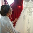 Bride looking at Florence wedding dress by Maggie Sottero