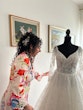 Bride Admiring Her Glam Long Sleeve Wedding Dress Called Seneca By Sottero And Midgley