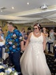 Bride wearing Natasha by Rebecca Ingram holding hands with her husband