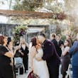 Bride Wearing A-line Bridal Dress Ainsleigh By Rebecca Ingram Kissing Groom With Family Cheering