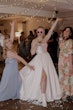 Bride wearing Scarlet by Maggie Sottero dancing with friends at her reception