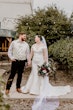 Bride Wearing Simple Fit And Flare Wedding Dress Called Josie By Rebecca Ingram With Groom Holding Hands