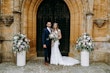 Newlyweds stood outside church, bride wearing wedding dress called Celeste.