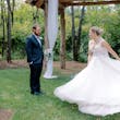 Bride twirling her skirt of wedding dress called Pierce as groom watches lovingly.