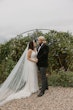 Bride wearing Luella wedding dress by Sottero and Midgley with her husband