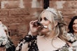 Bride wearing Zander by Sottero and Midgley drinking from a flask