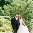Bride Wearing Beaded Wedding Dress Called Marvine By Sottero And Midgley Walking With Groom In A Garden