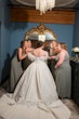 Bride wearing Derrick by Maggie Sottero laughing with her bridesmaids