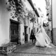 Bride wearing Iris wedding dress by Rebecca Ingram walking with her husband