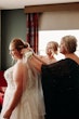 Bride wearing Pia wedding dress by Maggie Sottero has veil put on