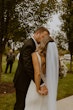 Bride Wearing Simple Fit-and-Flare Wedding Dress Called Fernanda By Maggie Sottero With Groom