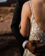 Groom Hugging Bride Wearing A White Wedding Dress Named Keisha By Maggie Sottero