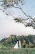 Bride wearing Winter by Maggie Sottero touches foreheads with her husband