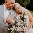 Groom and Bride at an Outdoor Wedding Wearing Lace Ballgown Wedding Dress Called Olivia by Rebecca Ingram