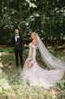 Bride wearing Hattie Lynette by Rebecca Ingram holding hands with her husband