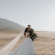 Bride And Groom Together. Bride Wearing Simple Ball Gown Wedding Dress With An Elegant Overskirt Called Kyrie By Maggie Sottero