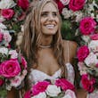 Bride Wearing Sparkly Ballgown Wedding Dress Called Shasta By Sottero And Midgley With Pink And White Rose Bouquets Surrounding Her