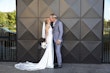 Bride wearing Audrina by Maggie Sottero kissing her husband