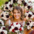 Bride wearing Hamilton wedding dress by Sottero and Midgley surrounded by bouquets