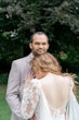 Bride wearing Nikki by Maggie Sottero resting her head on her husband