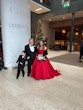 Bride Wearing Red Aline Wedding Dress Called Scarlet By Maggie Sottero Next To A Christmas Tree And Groom And Child