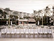 Table at wedding reception with fairy lights strung above.