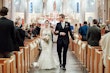 Groom looking at his bride walking up the aisle after saying I do! 