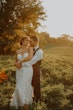 Bride wearing Marguerite wedding dress by Maggie Sottero being held by her husband