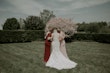 Real Bride in Illusion V-Back Sheath Wedding Gown with Lace Motifs and Side Illusion Panels Called Angie by Rebecca Ingram
