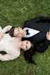 Bride wearing Zander by Sottero and Midgley laying with her husband