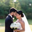 Groom Posing With Bride In Beaded Wedding Dress Named Positano By Sottero And Midgley With Long Veil And Flowers