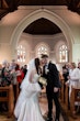 Bride wearing Saratoga by Maggie Sottero kissing her husband in the aisle