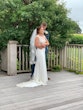 Groom hugging his bride who is wearing wedding dress called Jayleen