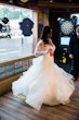 Bride Wearing Long Sleeve Ball Gown Wedding Dress With A Tiered Organza Skirt Tessa By Rebecca Ingram