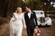 Groom Holding Hands with Bride in VIntage Inspired Puff Sleeve Mermaid Wedding Dress in 3-D Floral Motifs Called Cruz by Sottero & Midgley