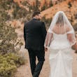 bride with groom in corset back fit and flare wedding dress
