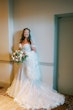 Bride Wearing Sexy Lace Wedding Dress Called Lennon By Maggie Sottero Holding A Bouquet