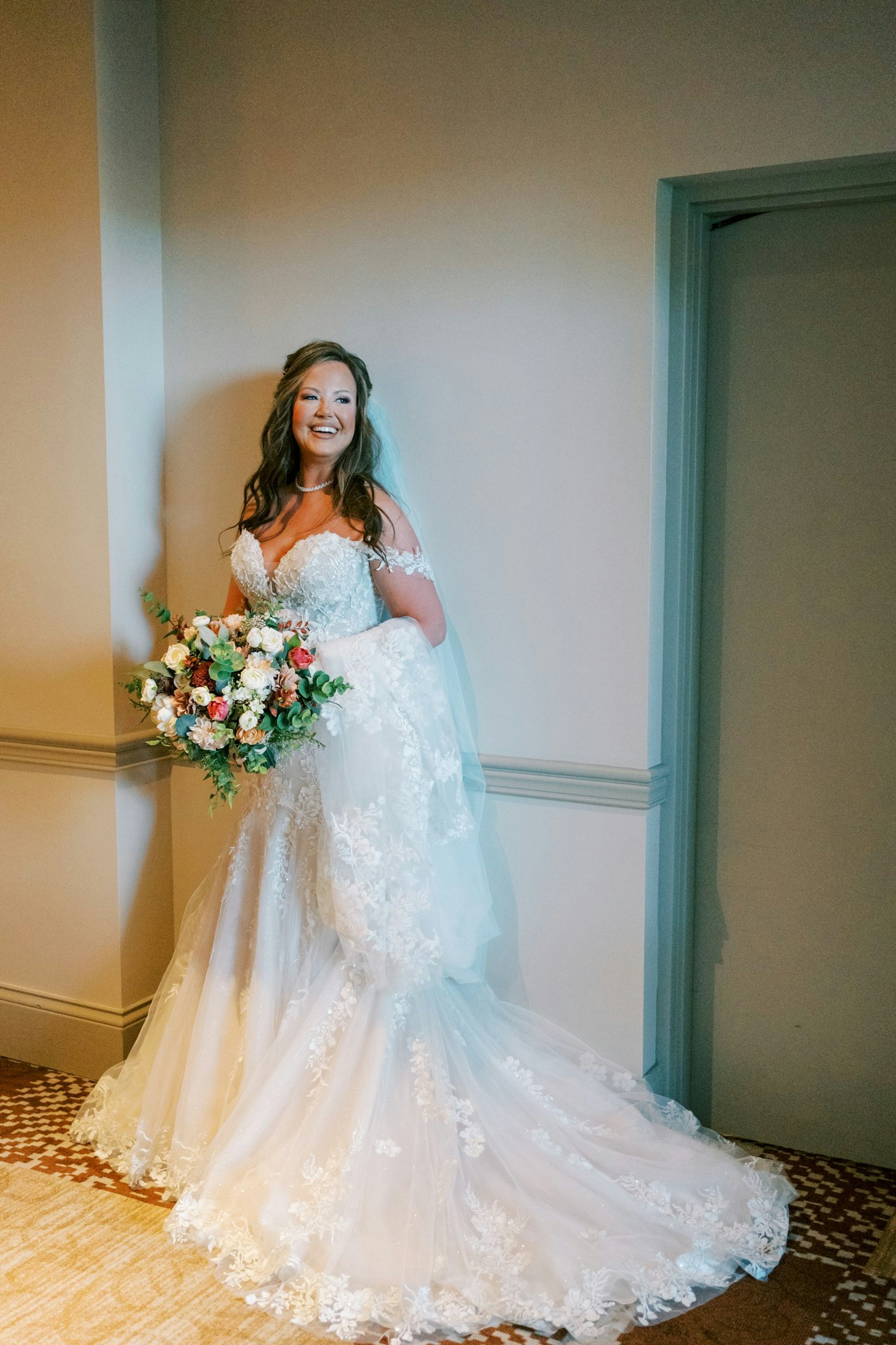 Bride Wearing Sexy Lace Wedding Dress Called Lennon By Maggie Sottero Holding A Bouquet