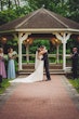 Bride wearing Fiona by Maggie Sottero kissing her husband at their ceremony