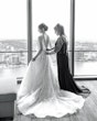 Bride wearing Marvine wedding gown by Sottero and Midgley as her mom zips her up