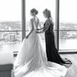 Bride wearing Marvine wedding gown by Sottero and Midgley as her mom zips her up