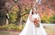 Bride Wearing Sparkly Aline Wedding Dress Called Anniston By Maggie Sottero Near A Tree With Fall Leaves