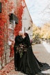 Bride Wearing Black Aline Wedding Dress Called Scarlet By Maggie Sottero With Groom Next To A Brick Building With Orange Vines