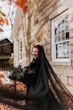 Bride Wearing Black Aline Wedding Dress Called Scarlet By Maggie Sottero Holding Dark Floral Bouquet