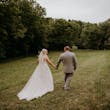 Groom and Bride at an Outdoor Wedding Wearing Lace Ballgown Wedding Dress Called Olivia by Rebecca Ingram