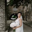 Bride Wearing Lace Backless Wedding Dress Called Chauncey By Sottero And Midgley Holding A White Bouquet