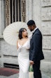 Bride wearing Moon by Maggie Sottero with her husband under a parasol