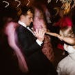 Groom Dancing with Bride in Vintage Inspired Puff Sleeve Mermaid Wedding Dress in 3-D Floral Motifs Called Cruz by Sottero & Midgley