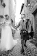 Bride wearing Iris wedding dress by Rebecca Ingram walking with her husband