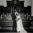 Bride wearing Hamilton wedding dress by Sottero and Midgley kissing her husband inside a church